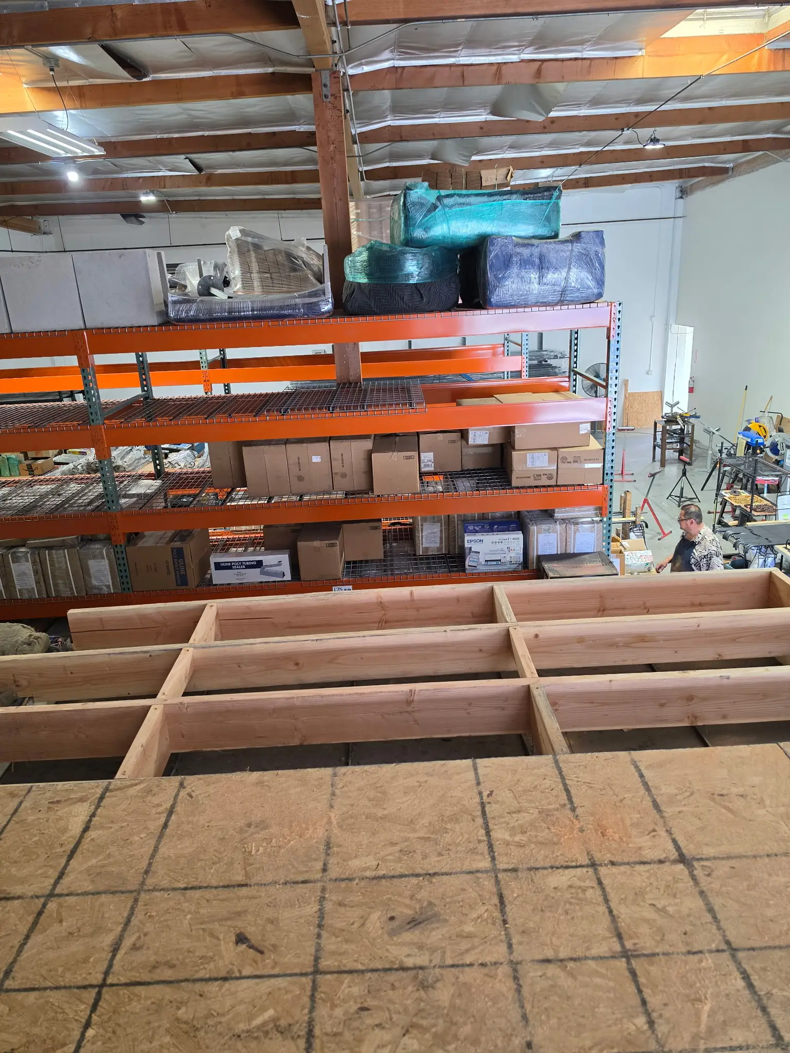 Structural framing for a mezzanine build-out inside an occupied warehouse